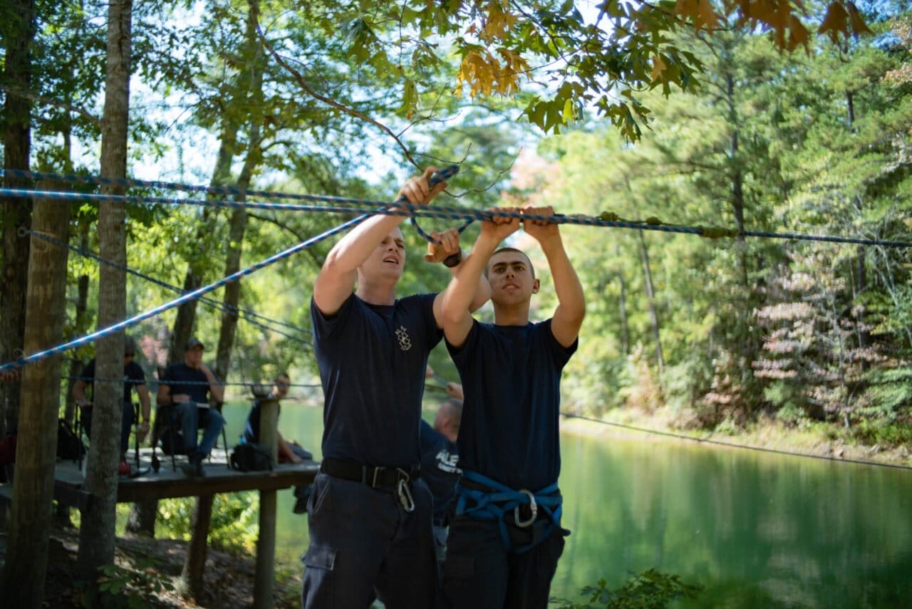 ALERT students working ropes as a team over water